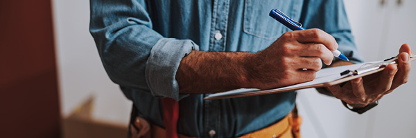 Handyman fills out service form for customer