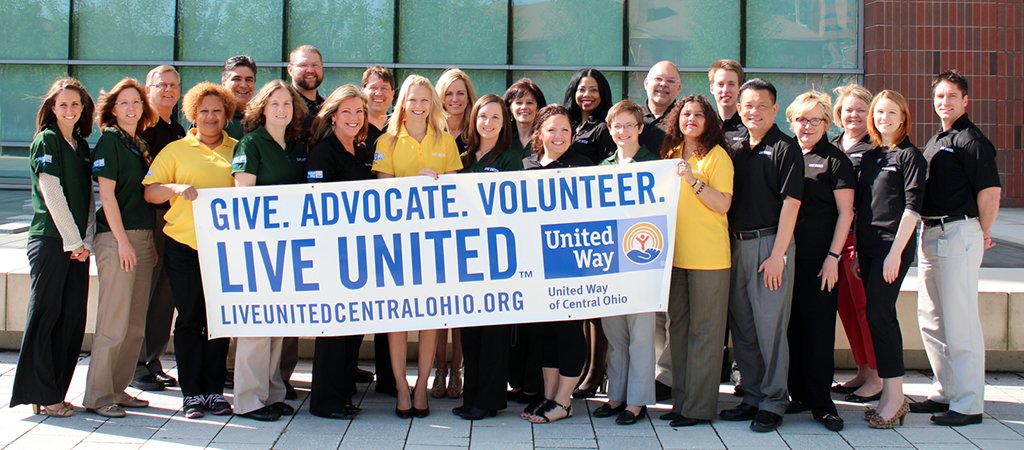 Group photo of Grange United Way volunteers holding a United Way banner reading: Give. Advocate. Volunteer.