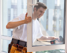 Contractor uses drill to install home window