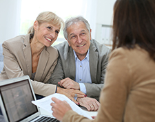 Married couple reviews their insurance at the insurance agent's office