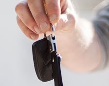 Man passes off car keys to a family member or friend