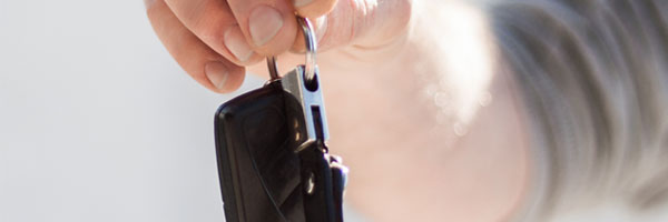 Man passes off car keys to a family member or friend