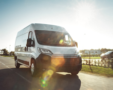 commercial van drives through industrial park