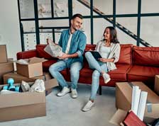 Couple opens moving boxes in condo