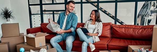 Couple opens moving boxes in condo