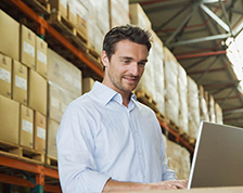 man in warehouse on computer