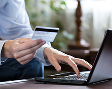 Man makes an online purchase using his credit card