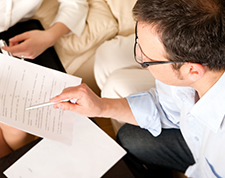 Man reviews insurance documents with agent