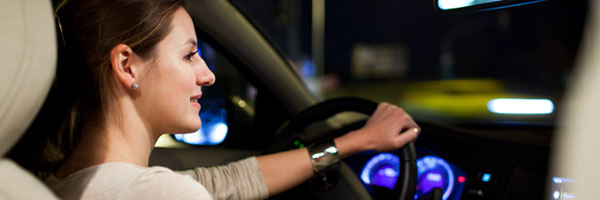 Woman turns right while driving at night