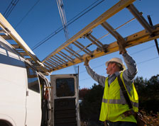 Contractor lifts ladder onto van