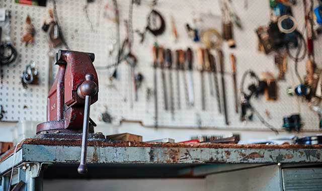 Workbench with tools hanging on the wall in a home garage