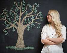 Woman with chalkboard drawing of money tree