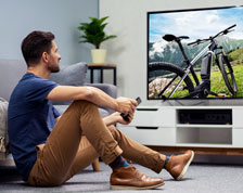 man watches TV in family room