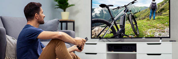 man watches TV in family room