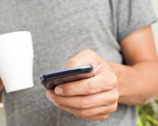 millennial man with coffee and smartphone