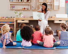 Teacher reads a picture book to students