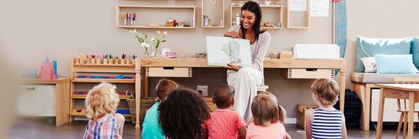 Teacher reads a picture book to students