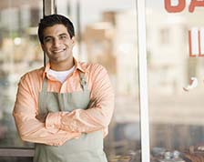 Man stands in front of his grocery store