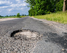 Pothole on a sunny country road