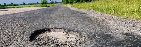 Pothole on a sunny country road