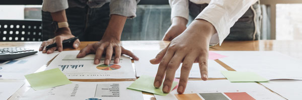 Two co-workers review business results during meeting