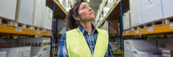Woman holding scanner works in warehouse