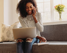 Young woman takes notes while submitting her insurance claim