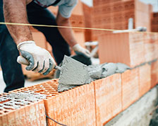 Construction worker lays bricks