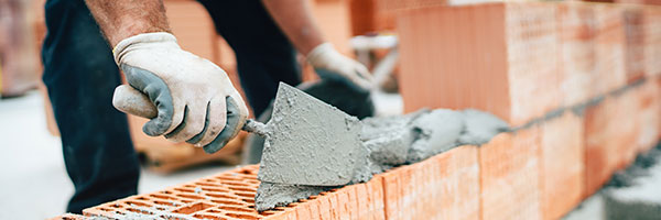 Construction worker lays bricks