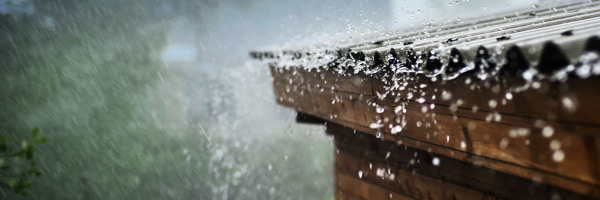 Heavy rain splashes off house roof