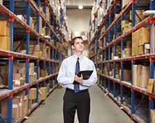 Man takes inventory inside a large warehouse