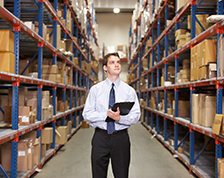 Man takes inventory inside a large warehouse