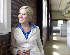 Successful business owner looks out her office window