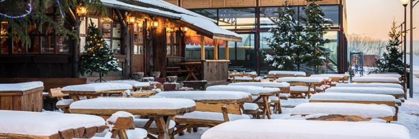 An outdoor restaurant patio covered in snow.