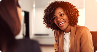 Insurance agent smiles while speaking with her client 