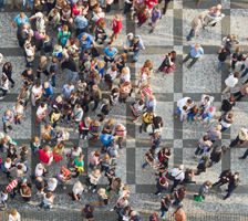 Aerial view of a crowd of people walking across a busy intersection
