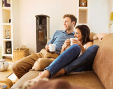 Man and woman sitting on couch in their home