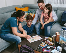family sitting on the couch going over documents