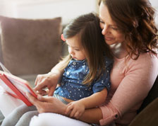 Woman and child read picture book together